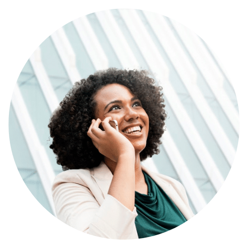 woman smiling while talking on the cell phone