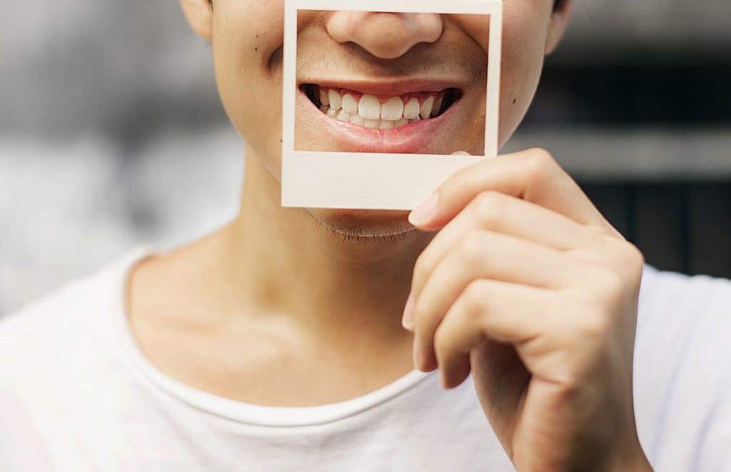 Guy holding a photo frame smiling