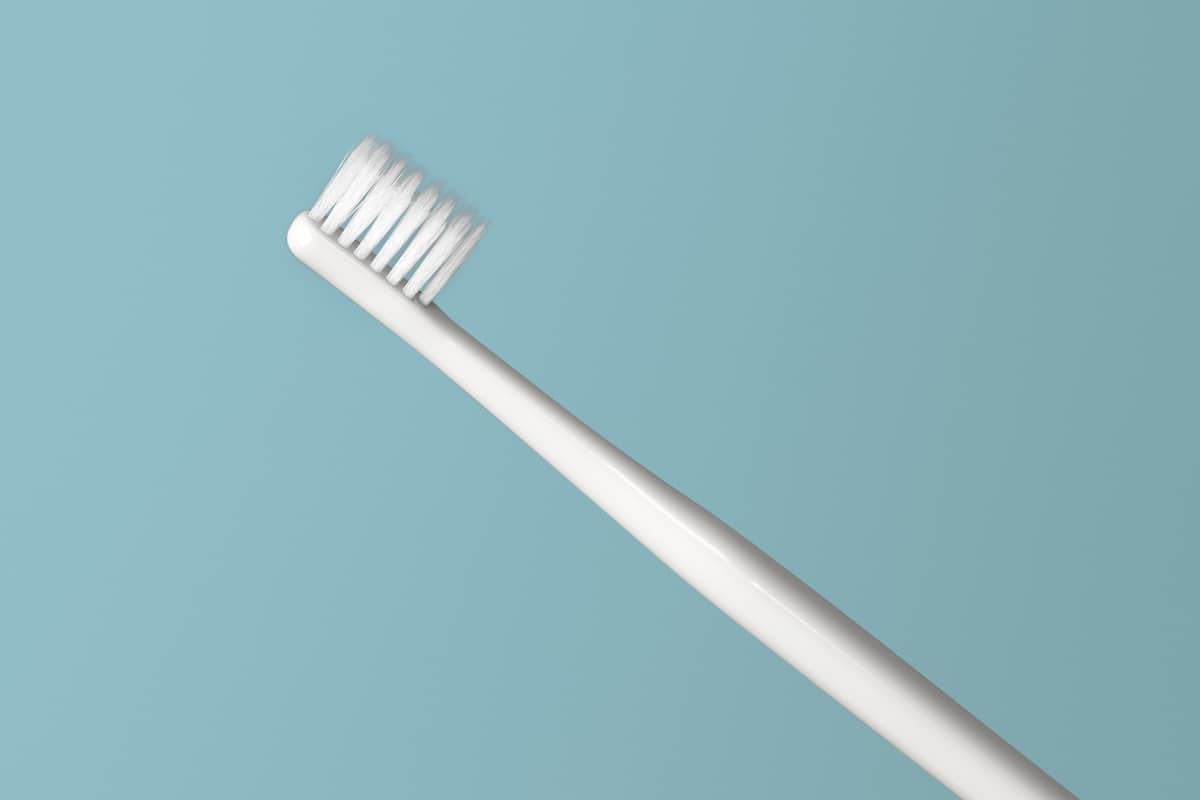 White toothbrush on a green background