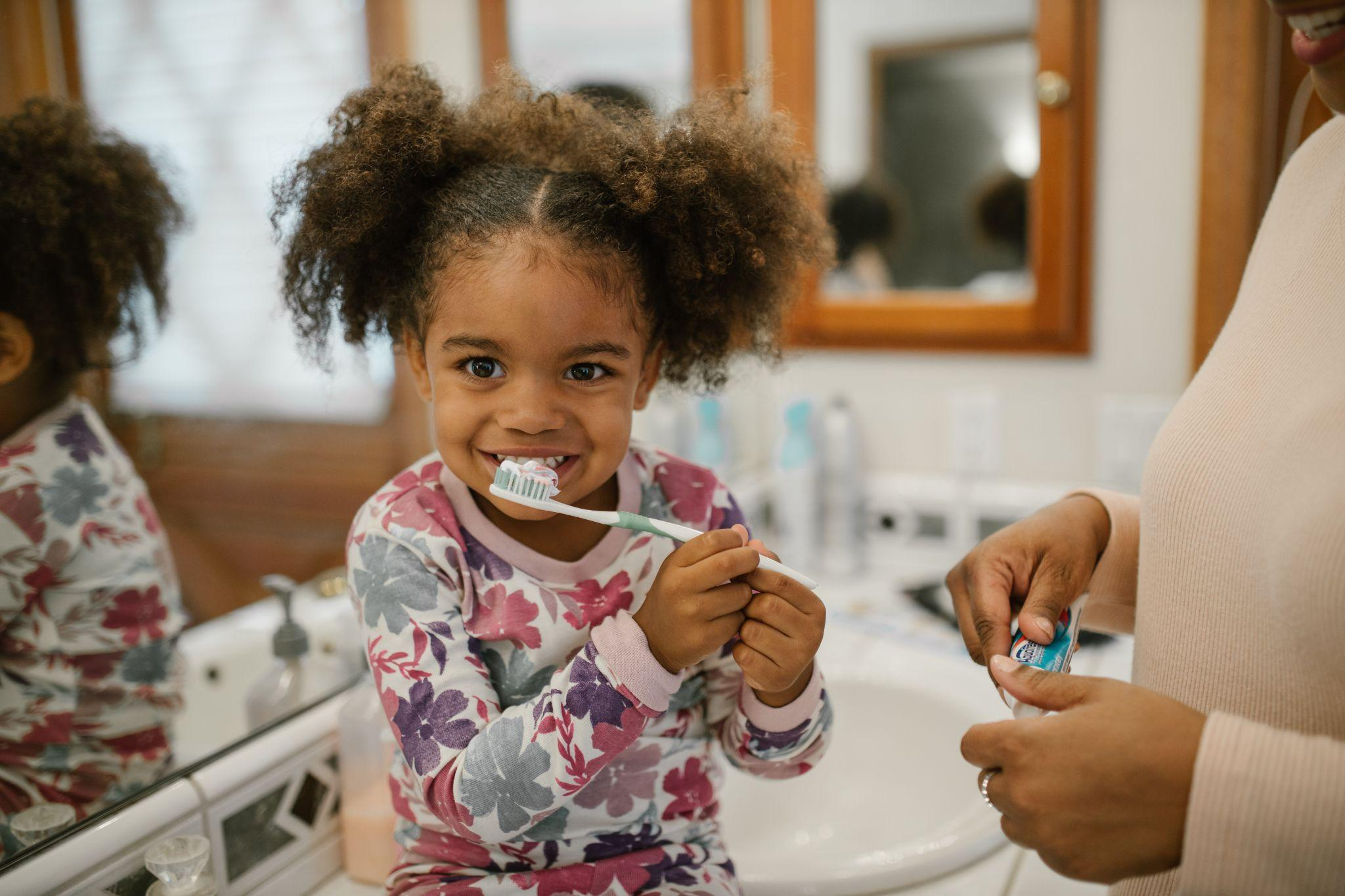 A little girl brushing her teeth