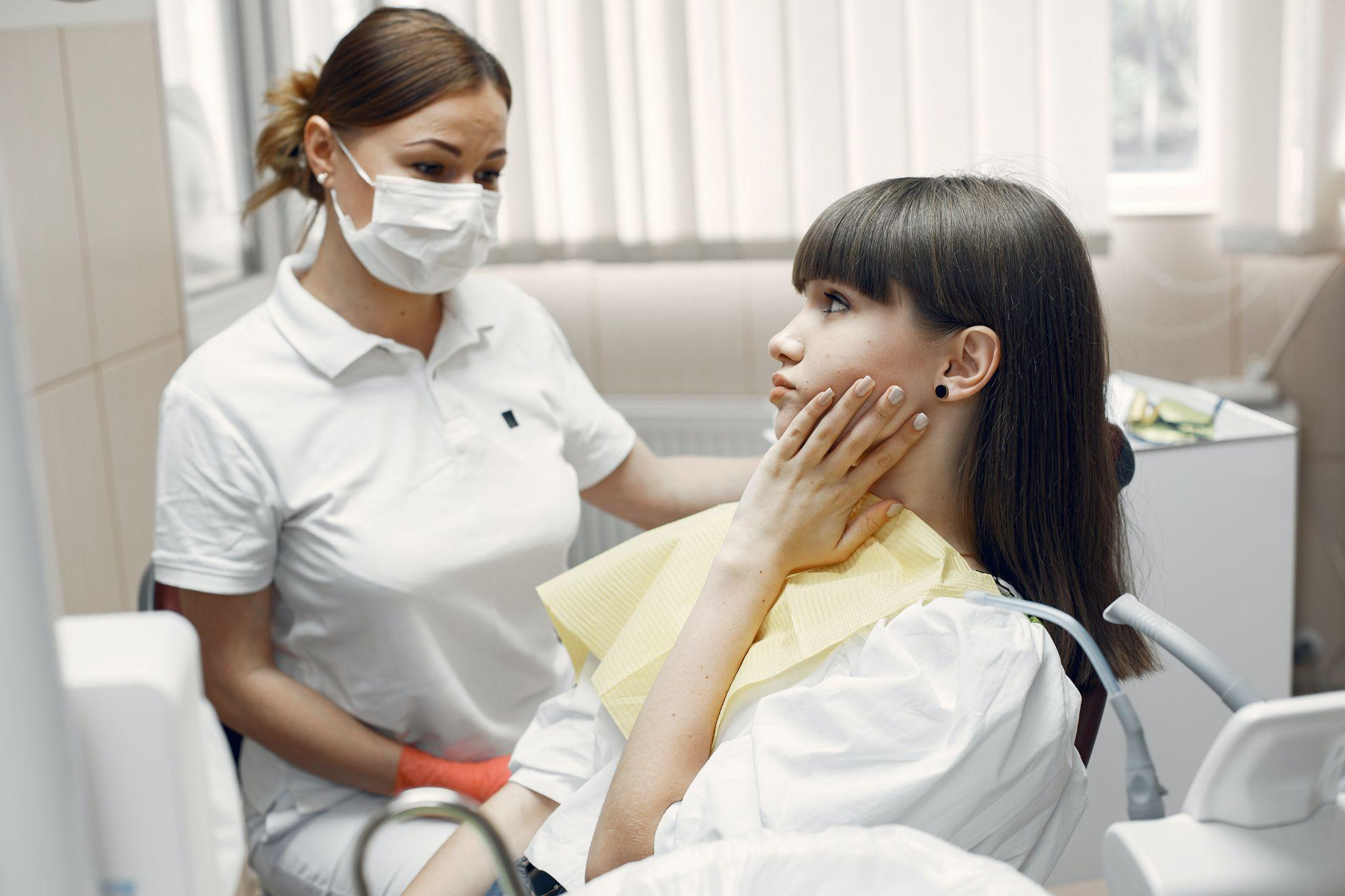 A woman with a toothache at a dental clinic in Gainesville