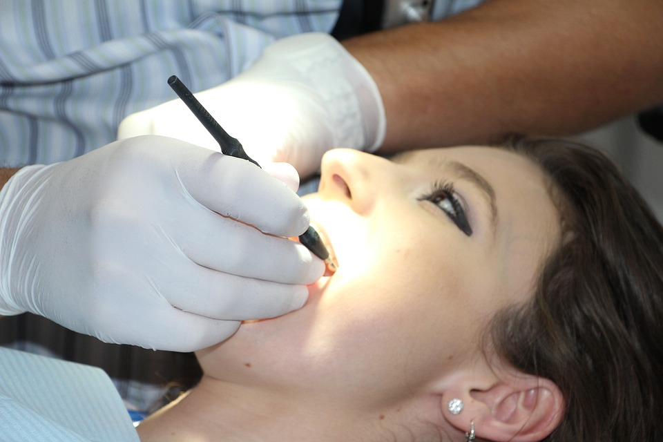 A dentist cleaning a patient’s teeth
